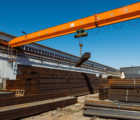 Gantry Crane Ticket Perth - Participant Operating Gantry Crane. Overhead Crane Training Perth - Overhead Crane in Operation. A bridge crane moving steel beams at an industrial facility during a crane operation course.