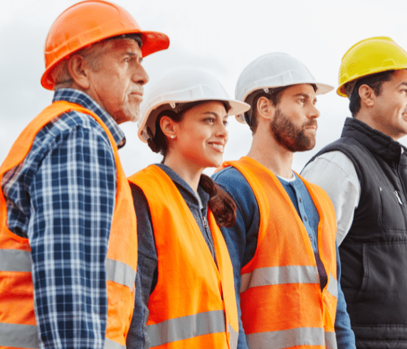 Group of workers in safety gear participating in an on-site vocational training session.